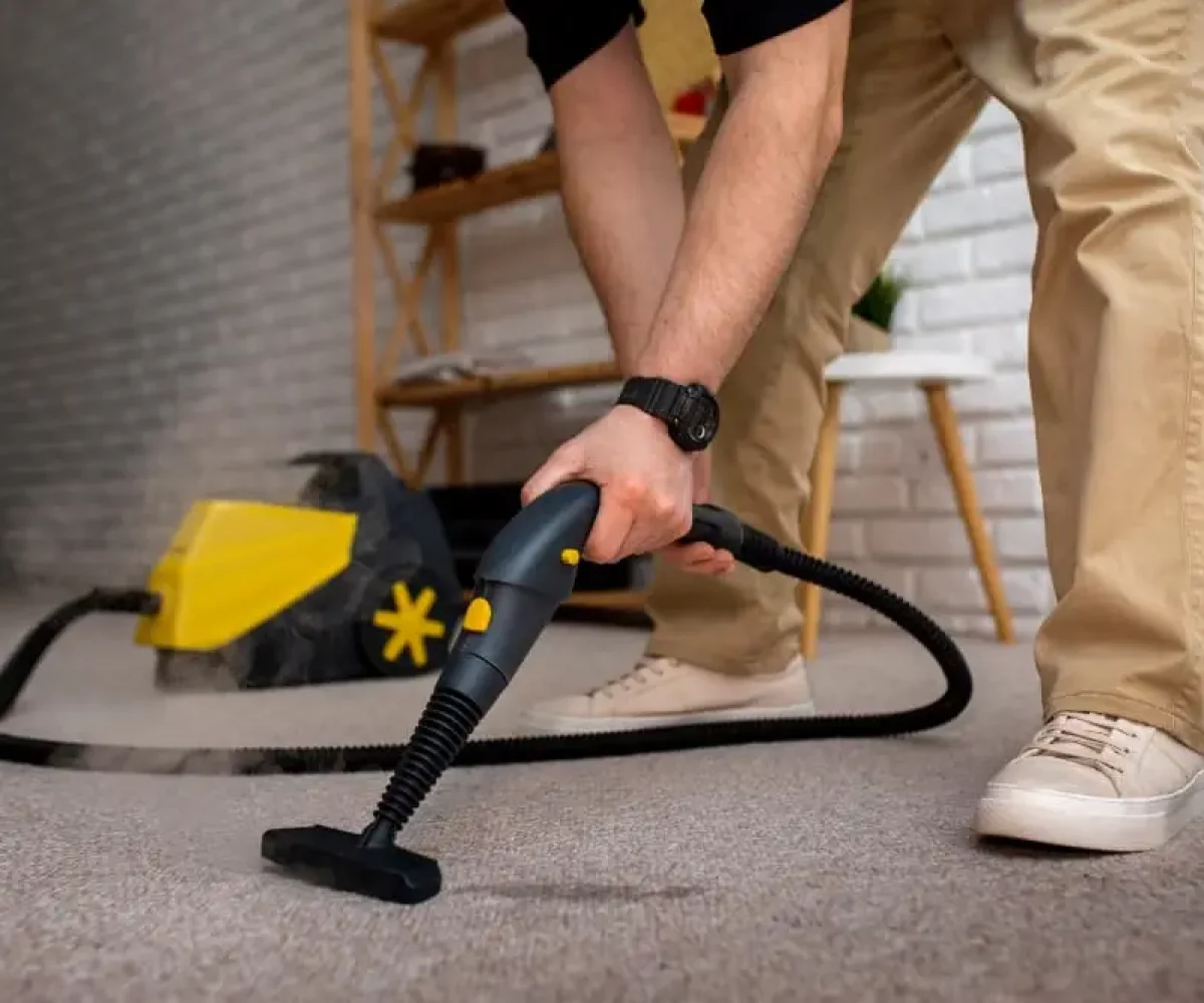 Teppich wird mit dem Dampfreiniger behandelt, Teppichreinigung von Cleanaro